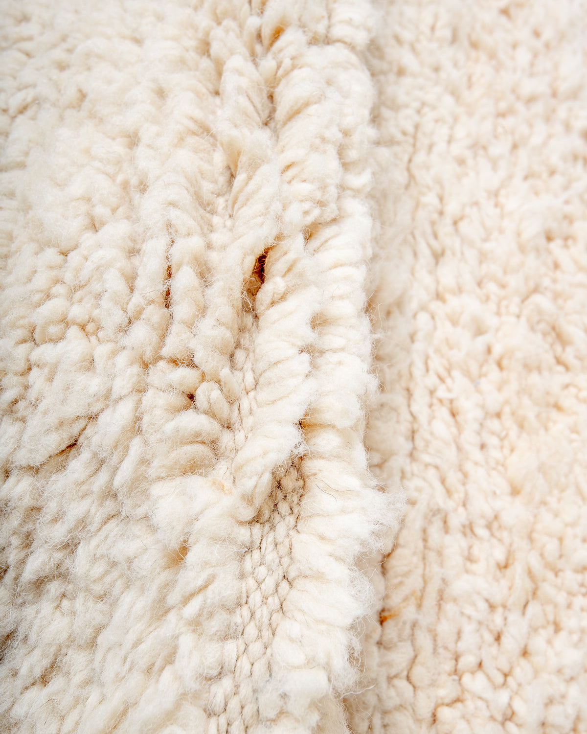 Modern, designer, handcrafted Berber rug from Morocco. Beniourain carpet with minimalist design, natural wool pile and a fluffy texture.